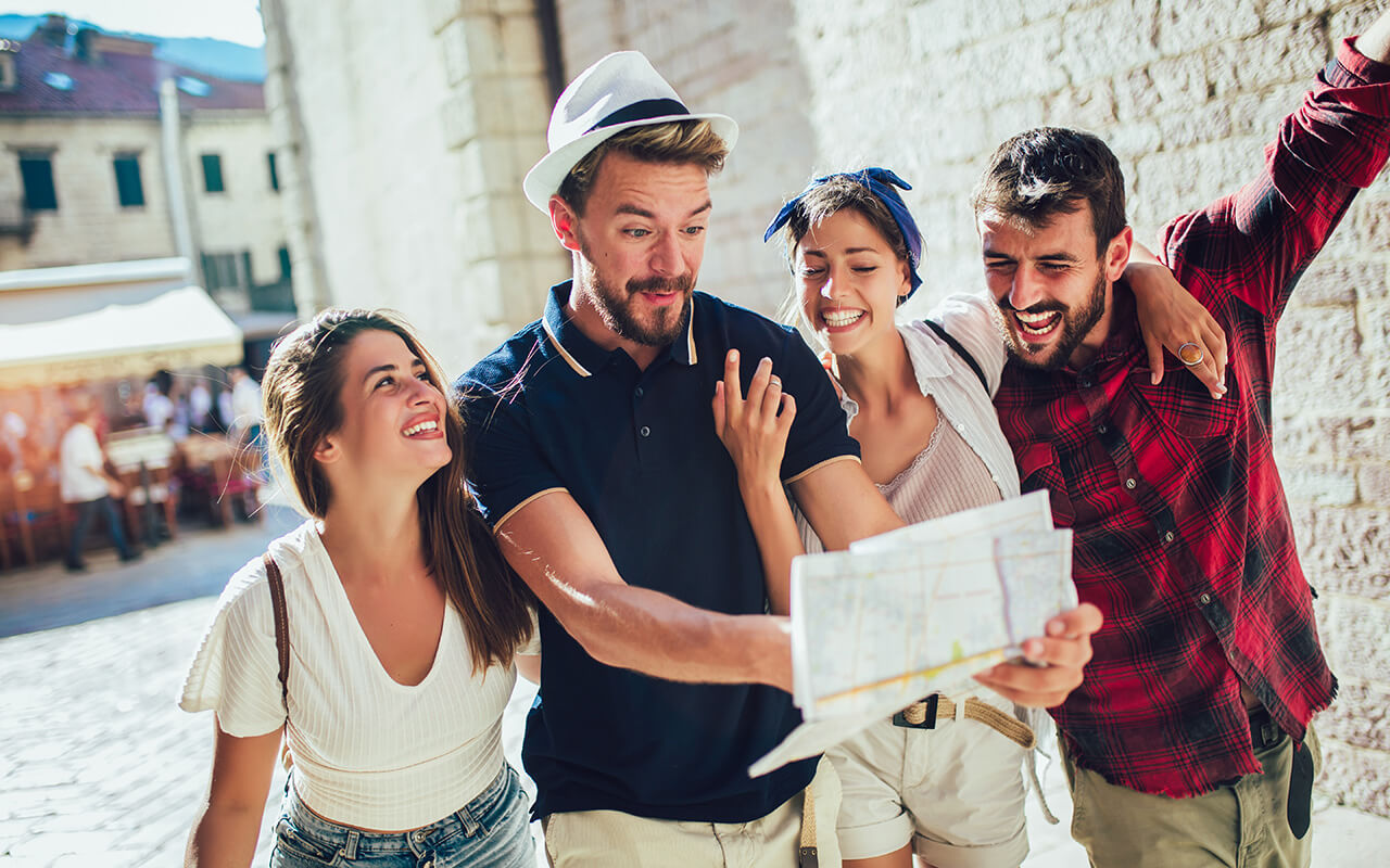 Group of people looking at a map while sightseeing 