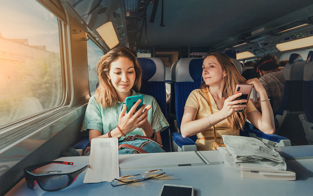 Women on a train using their phones