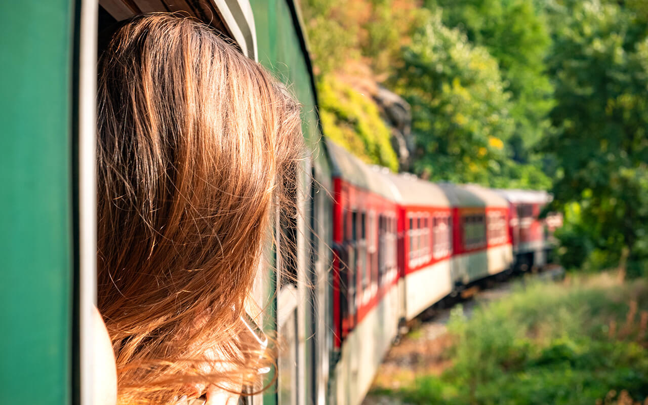 Woman looking out of a train window