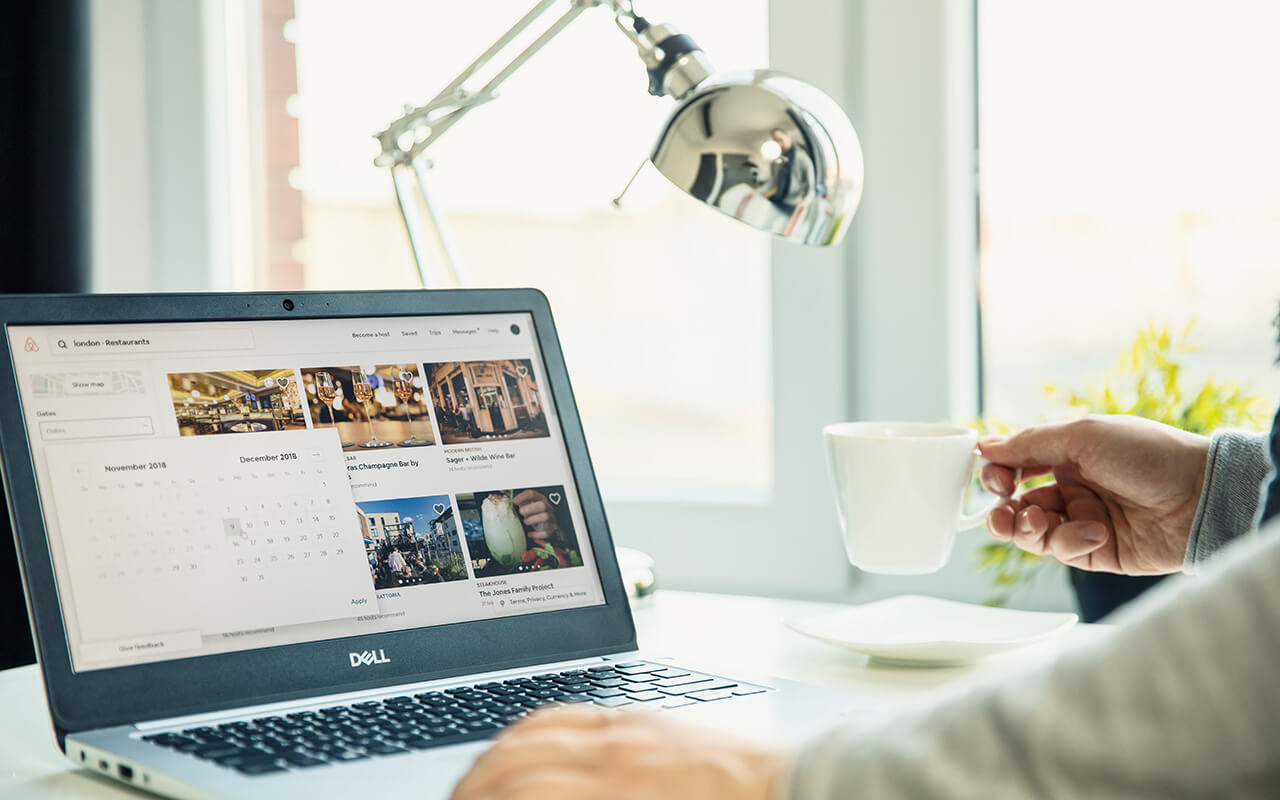 Person using Airbnb on a laptop