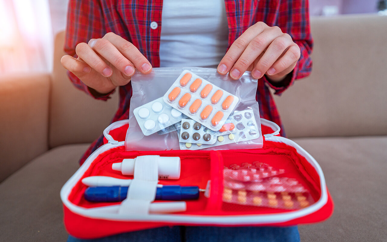 Person packing medications in a bag