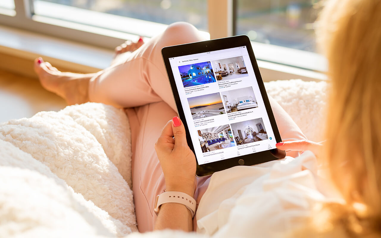 Woman using Airbnb app on iPad