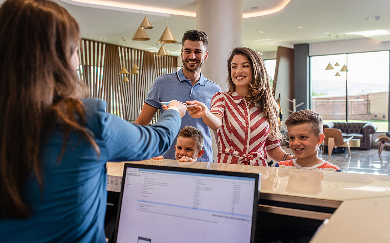 Family checking into a hotel