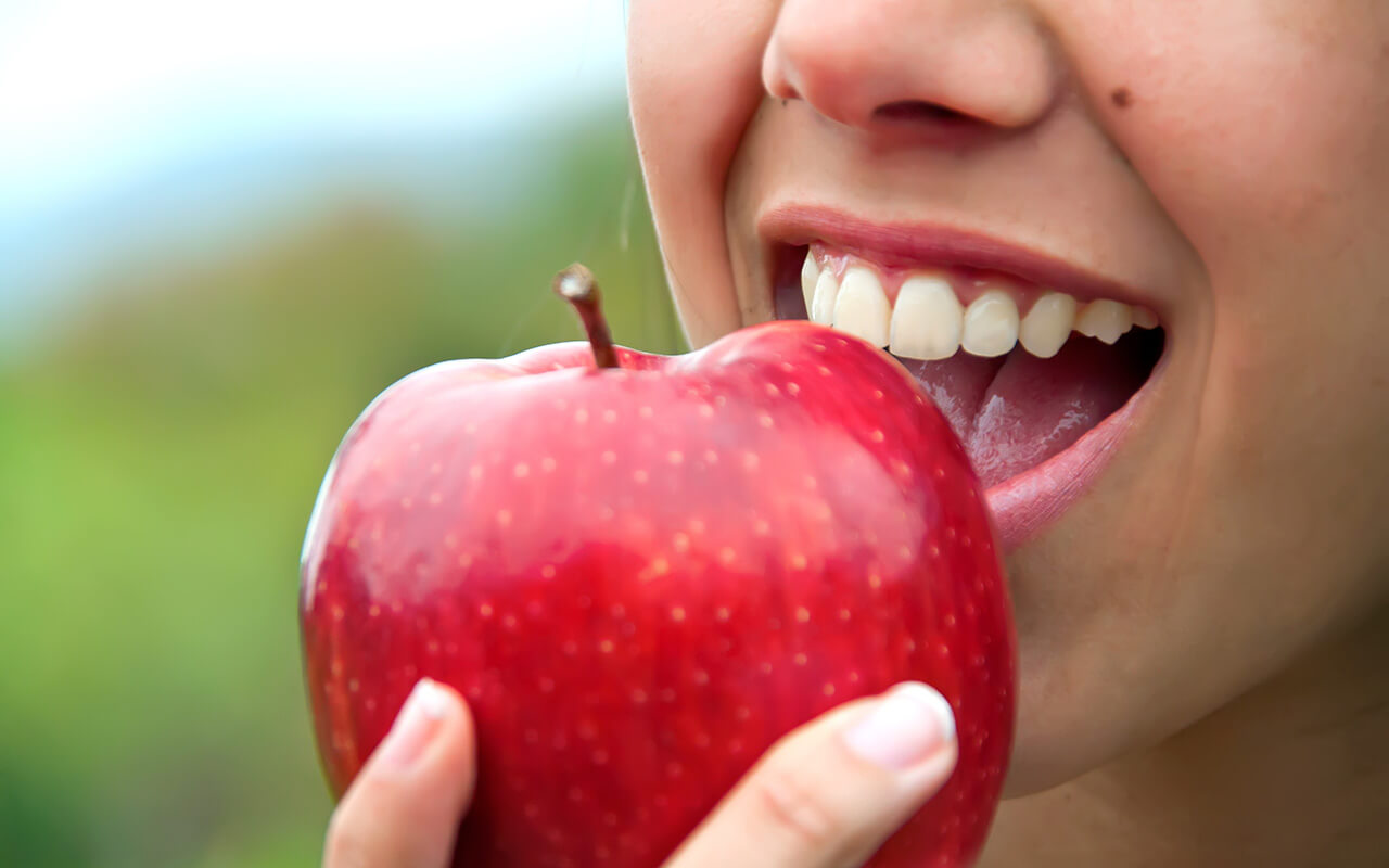 Woman eating an apple