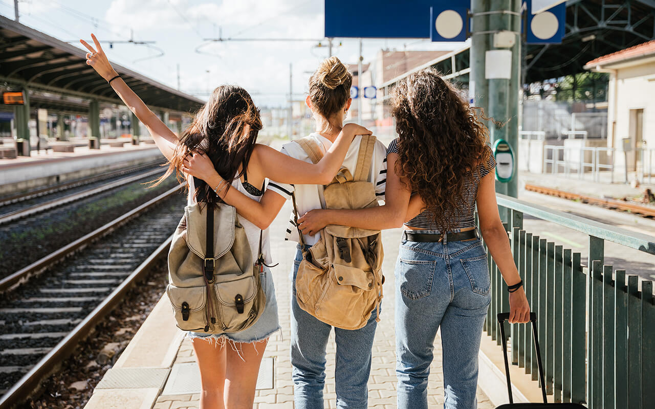 Three young women waiting for a train