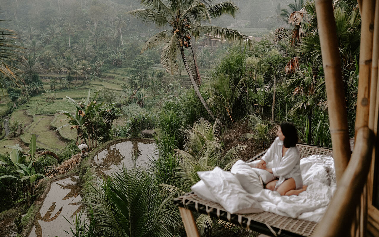 Woman overlooking Thailand from bed