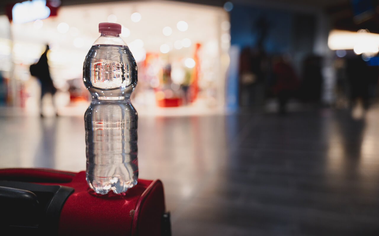 Close-up plastic bottle of water on a trolley in airport