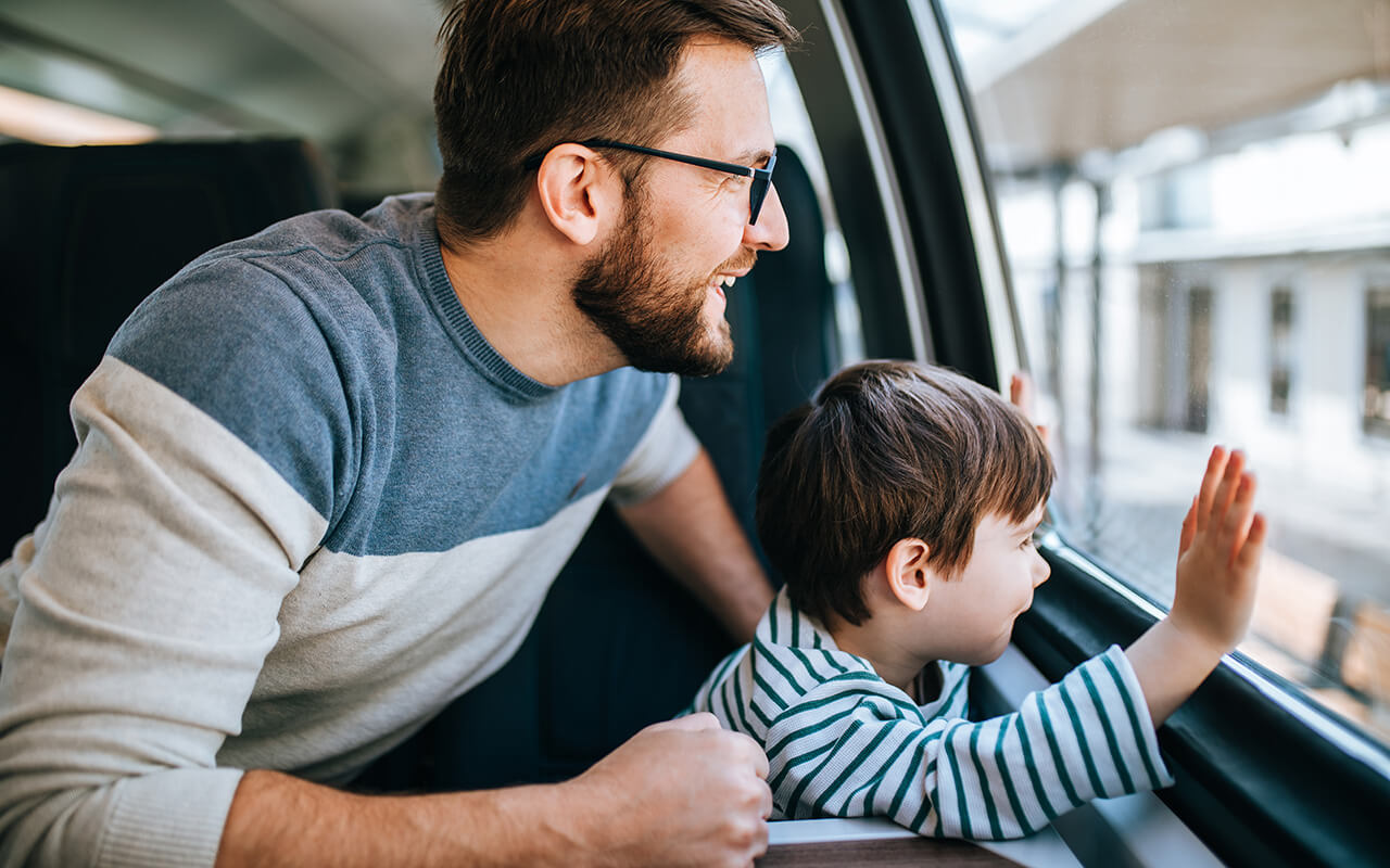 Father and son traveling by train