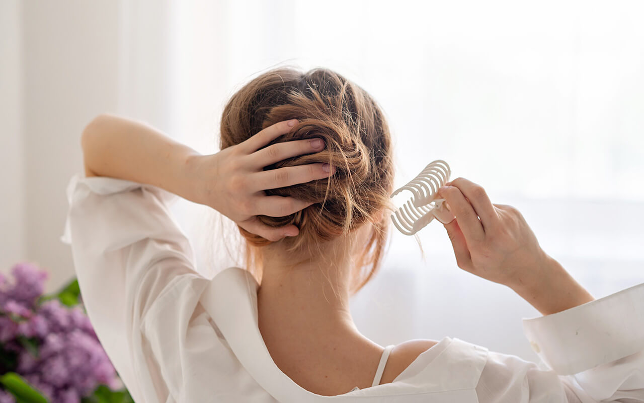 Woman putting a claw clip in her hair