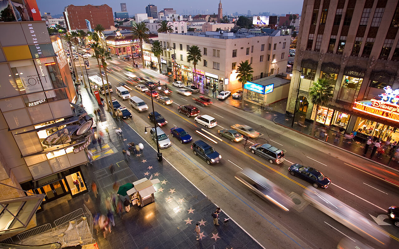 The Walk of Fame at the 6800 block of Hollywood Boulevard with the Dolby Theatre in the foreground and the intersection of Hollywood Boulevard and Highland Avenue