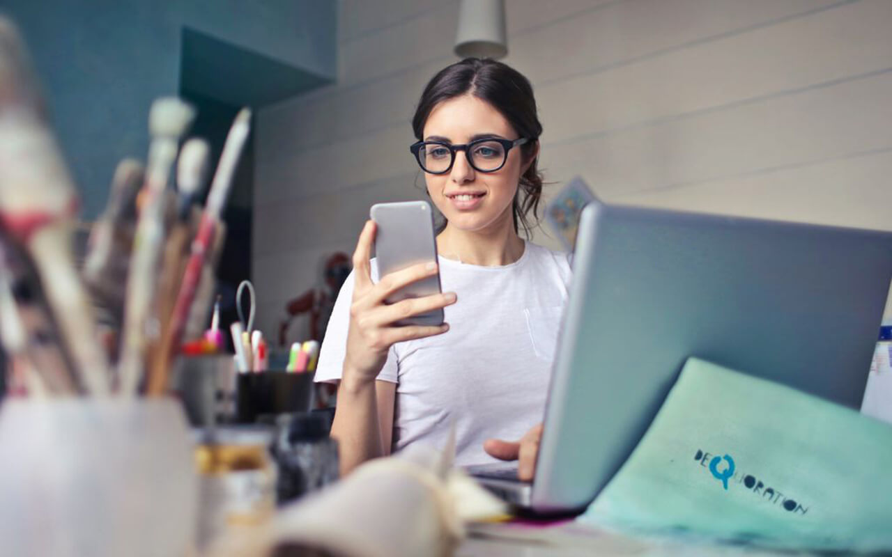 Woman looking at her phone in an office