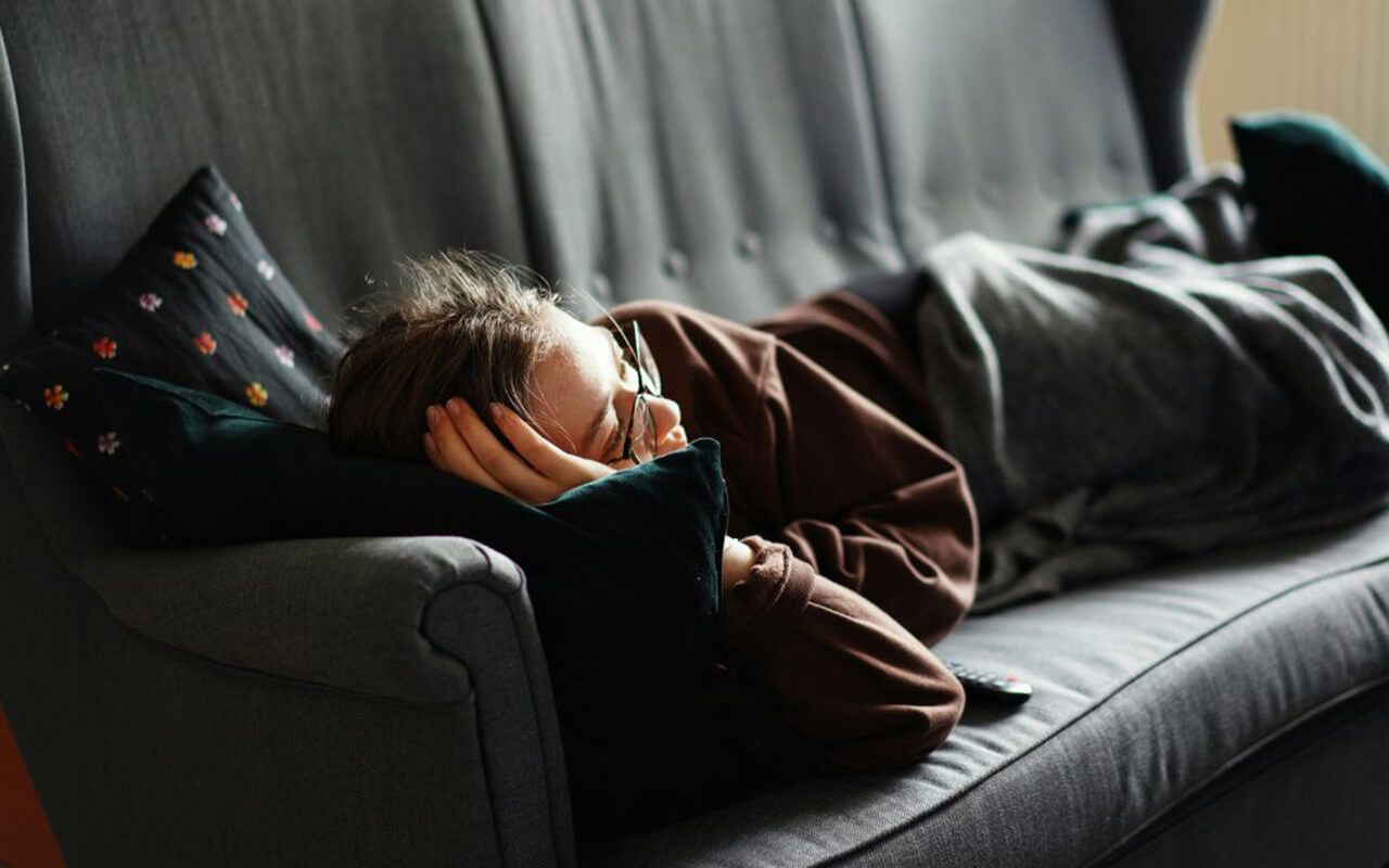 Person napping on a couch