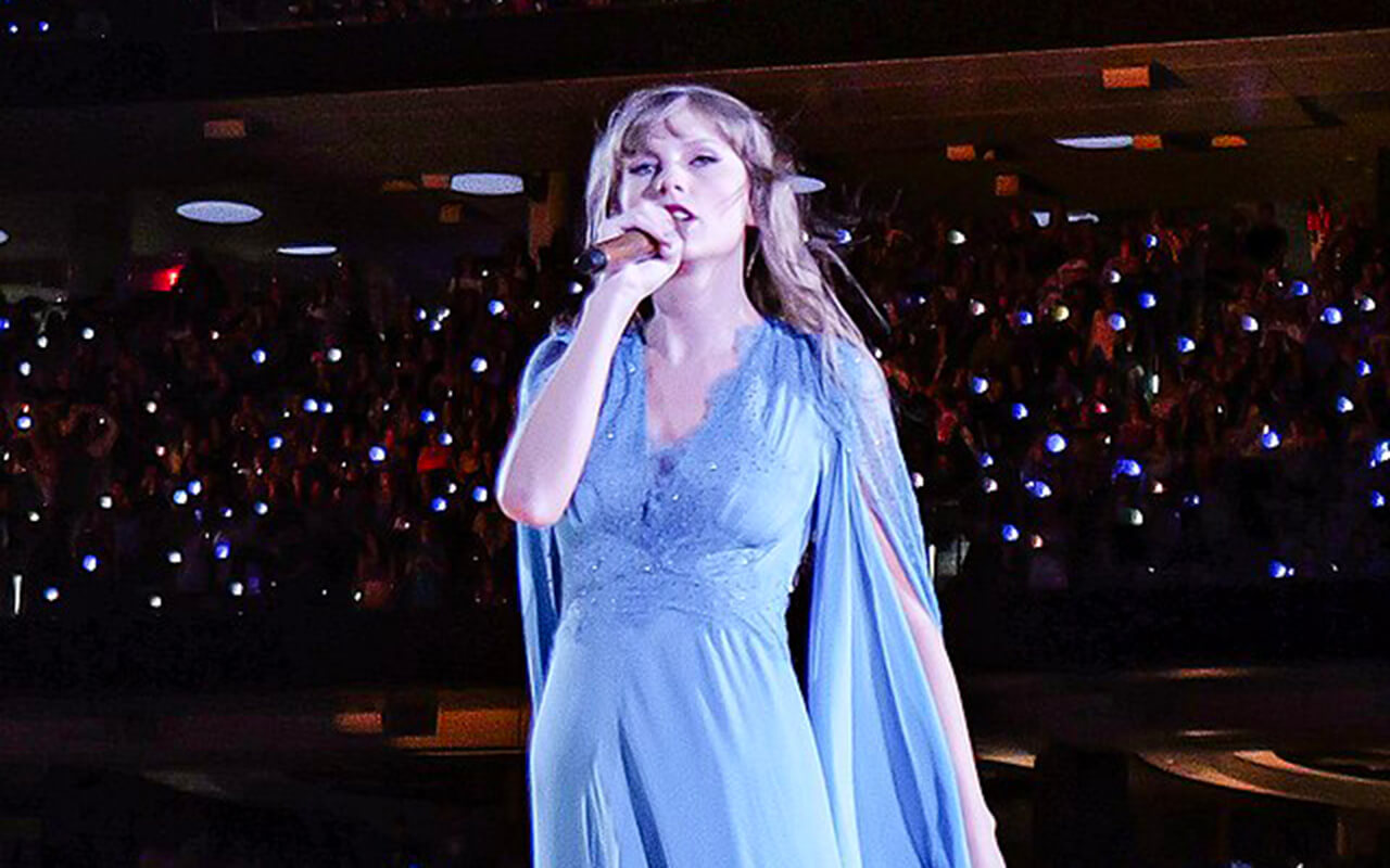 Taylor Swift performing the Folklore act in a blue dress