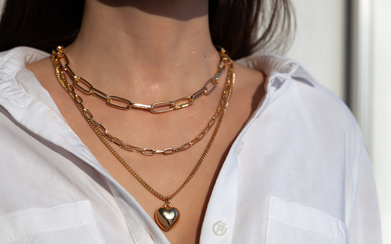 Woman wearing layered gold necklaces