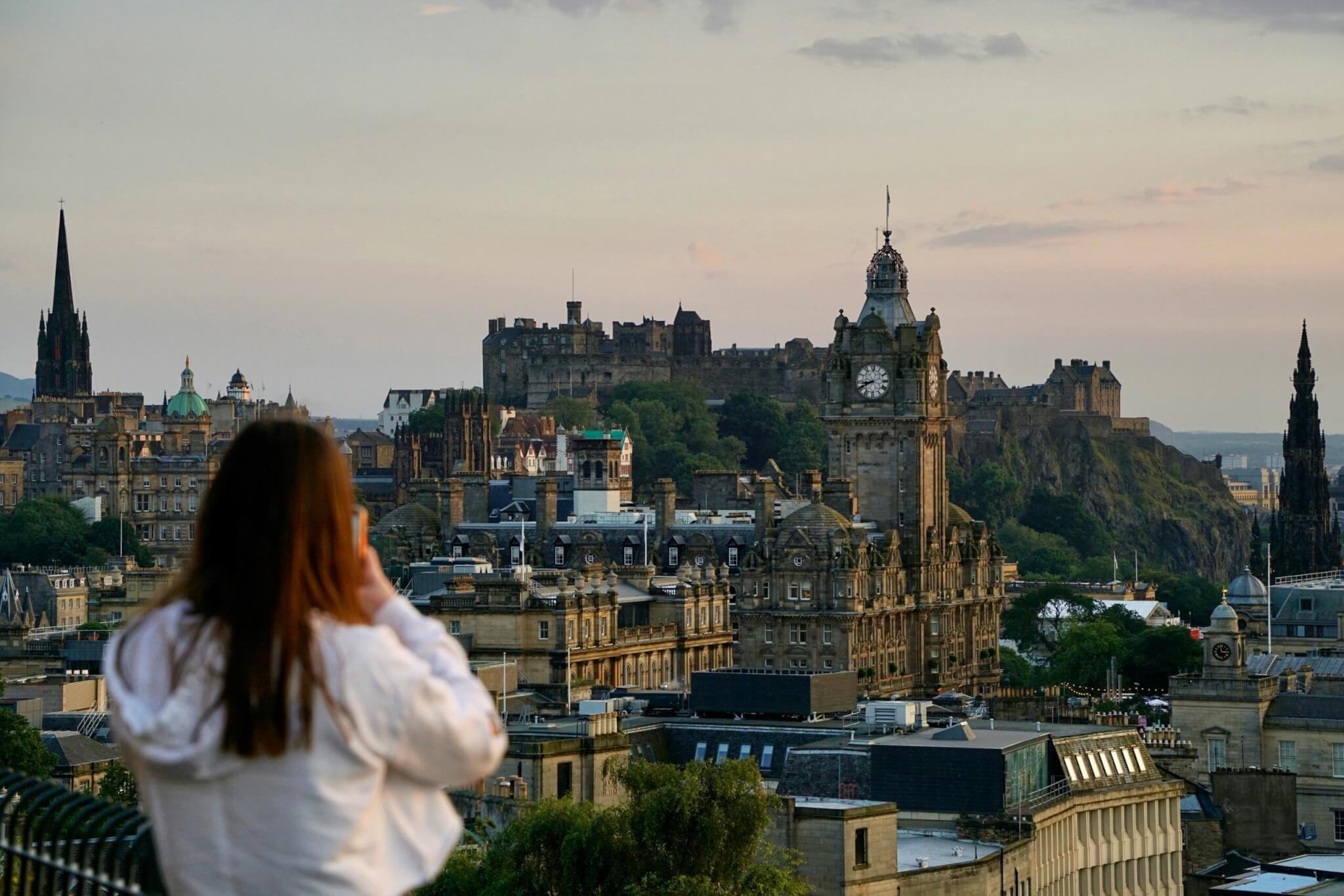 woman taking photo in edinburgh, scotland