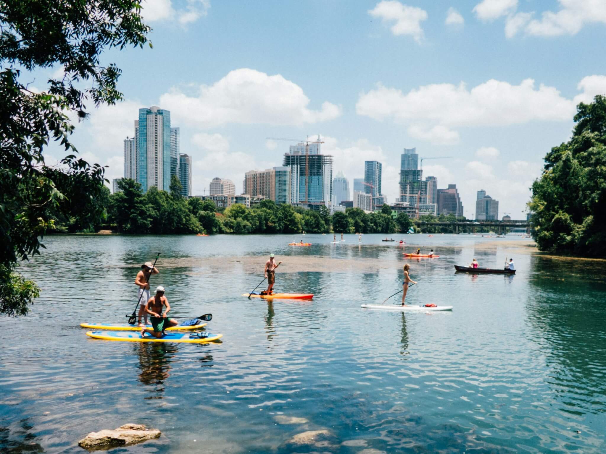 people kayaking on a lake in austin