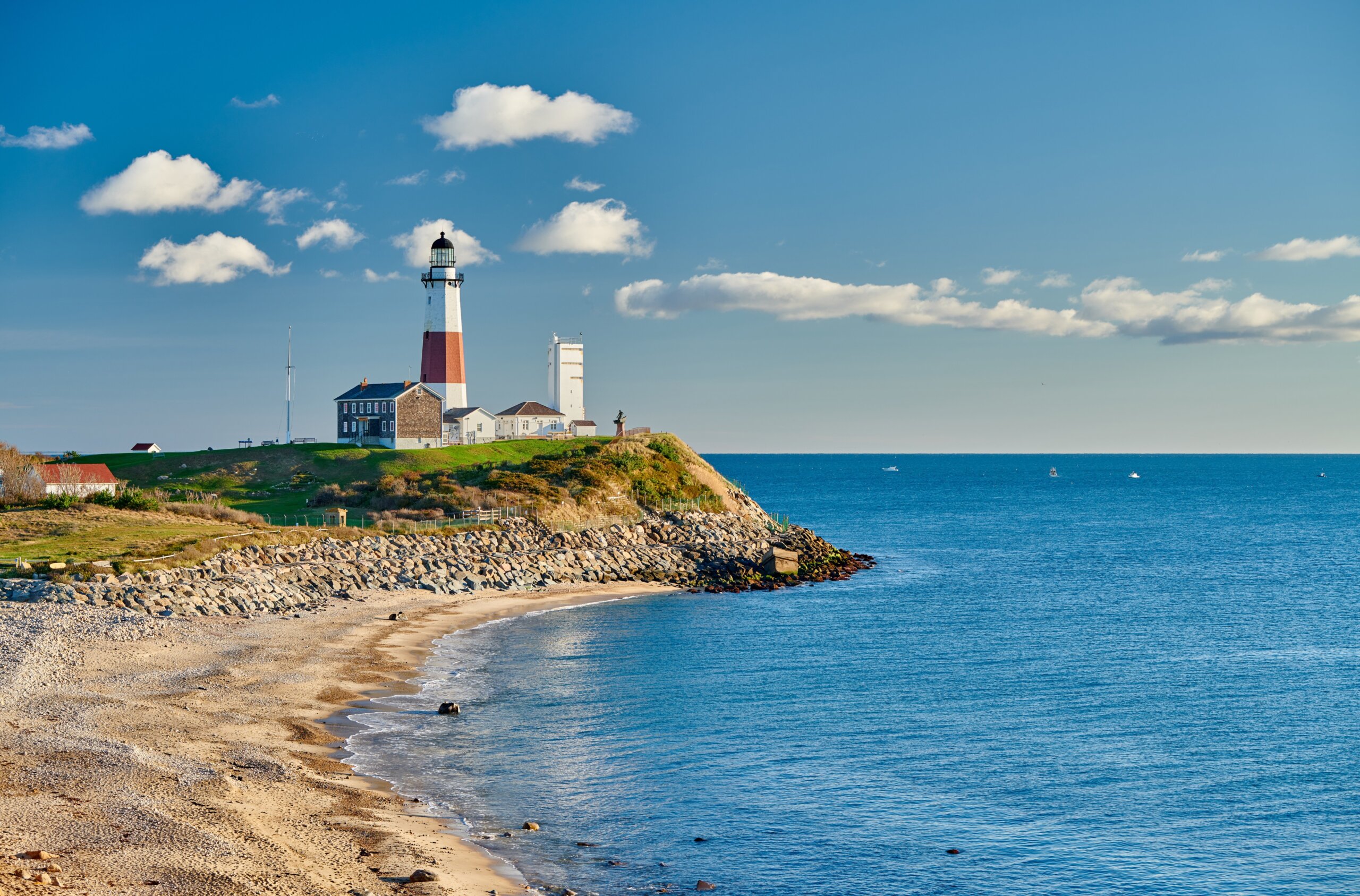 Montauk Lighthouse overlooking the ocean with rocky beach below, located on the eastern tip of Long Island, New York.