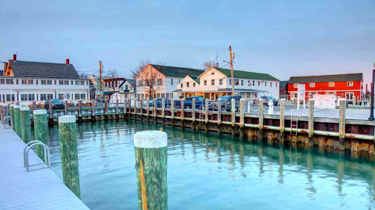 colorful houses line the water in front of a dock