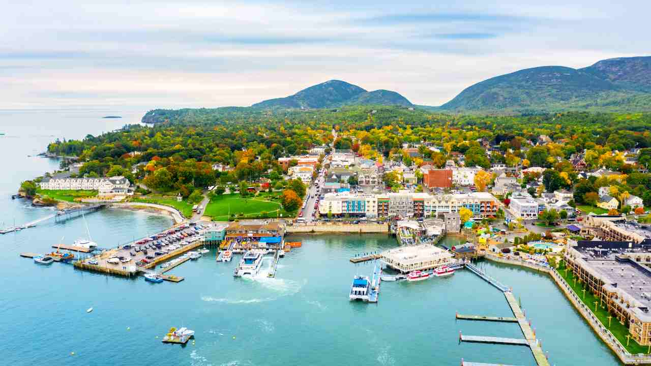 an aerial view of a small town on the shore of a body of water