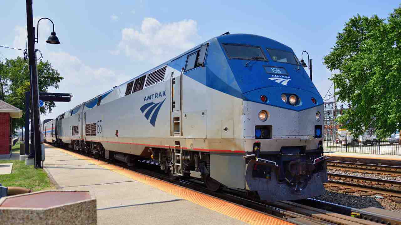 an Amtrak train is pulling into a station