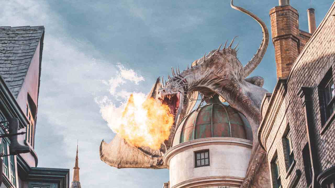 a dragon is flying over a building in the middle of a city