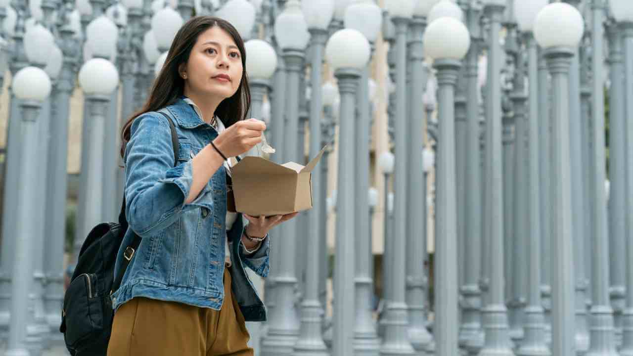 person in front of light poles at lacma