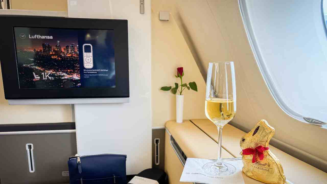 a glass of champagne sits on a table in front of a television