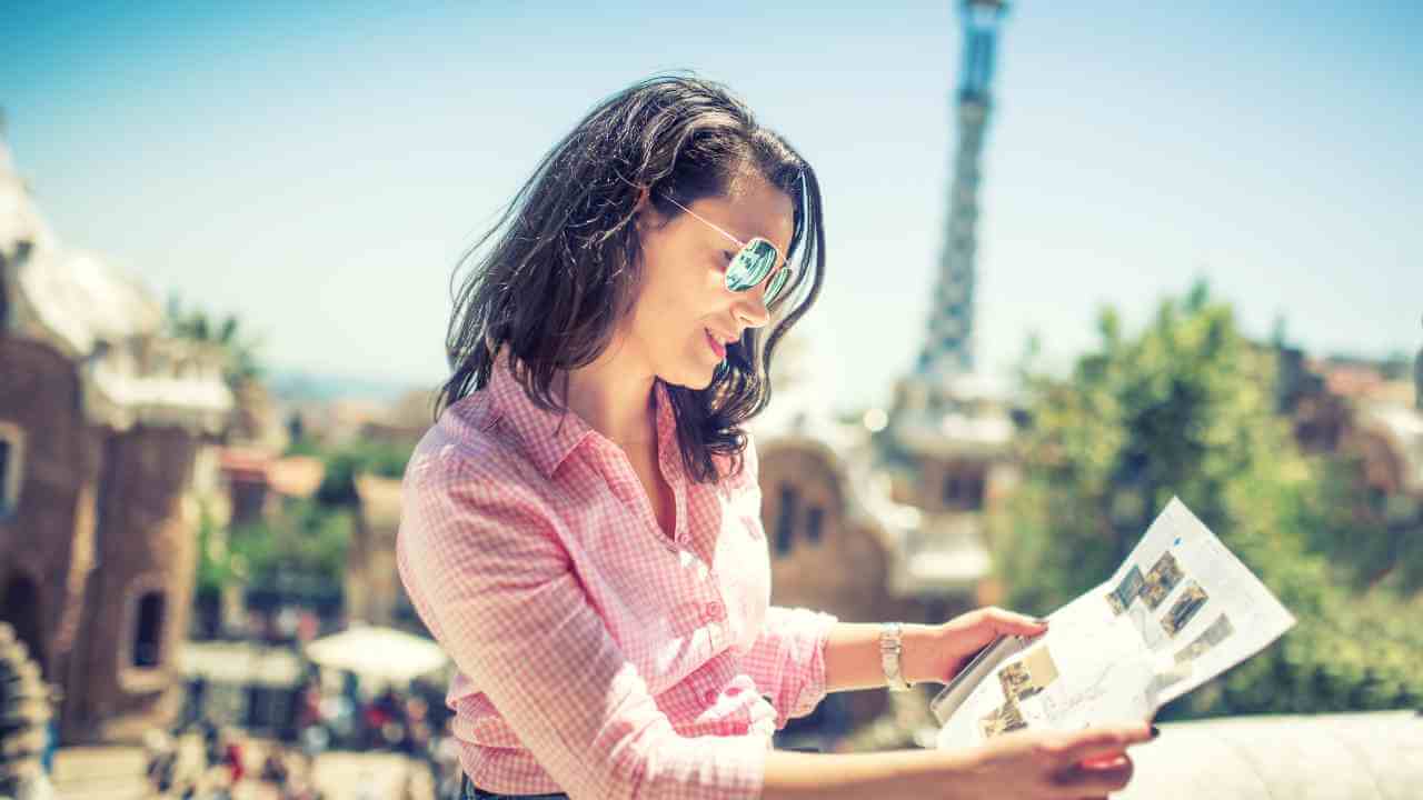 a person looking at a map in front of the eiffel tower