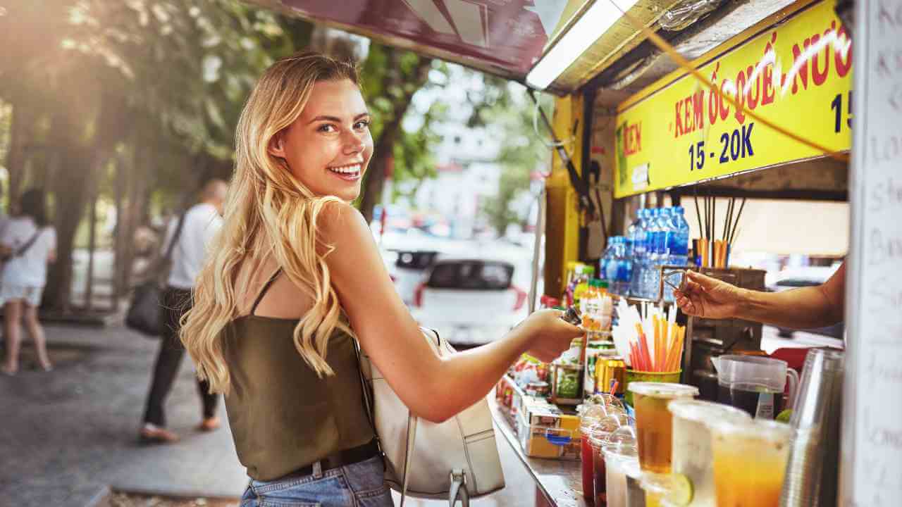 a person is standing in front of a food stand