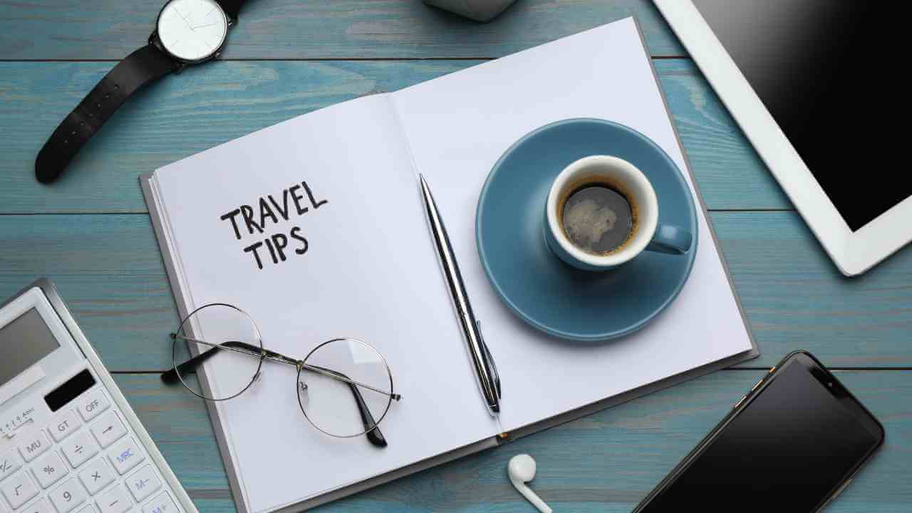 travel tips on a notebook with a cup of coffee and a calculator