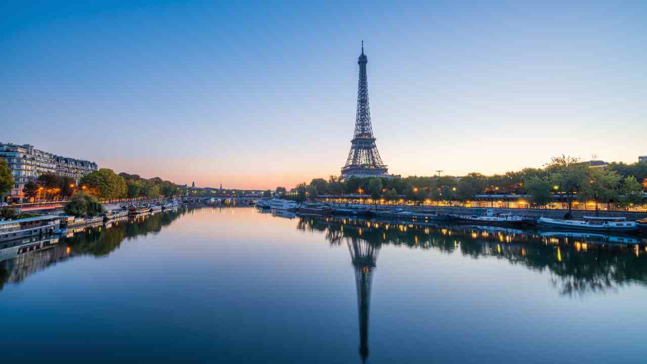 the eiffel tower is reflected in the water at dusk in paris, france