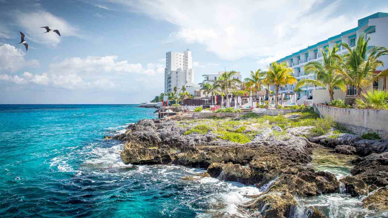 coast of cozumel island with hotels lining the sand