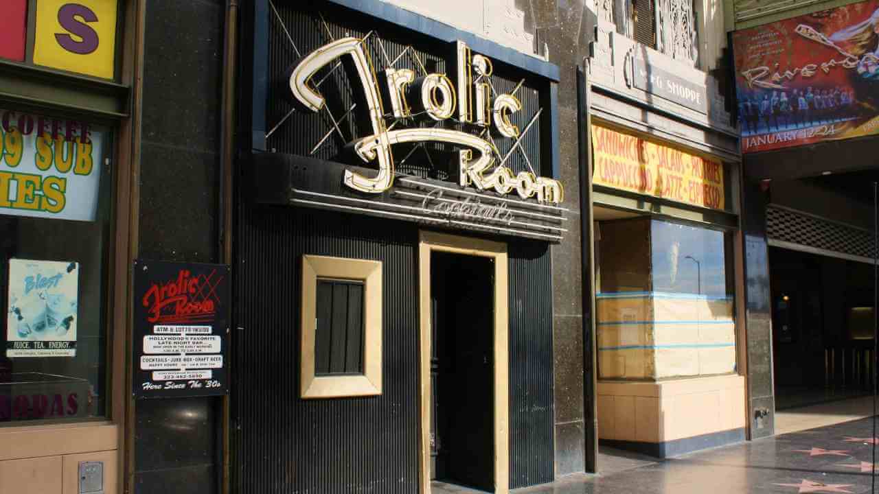 a building that has a sign that says "frolicroom" in front of it