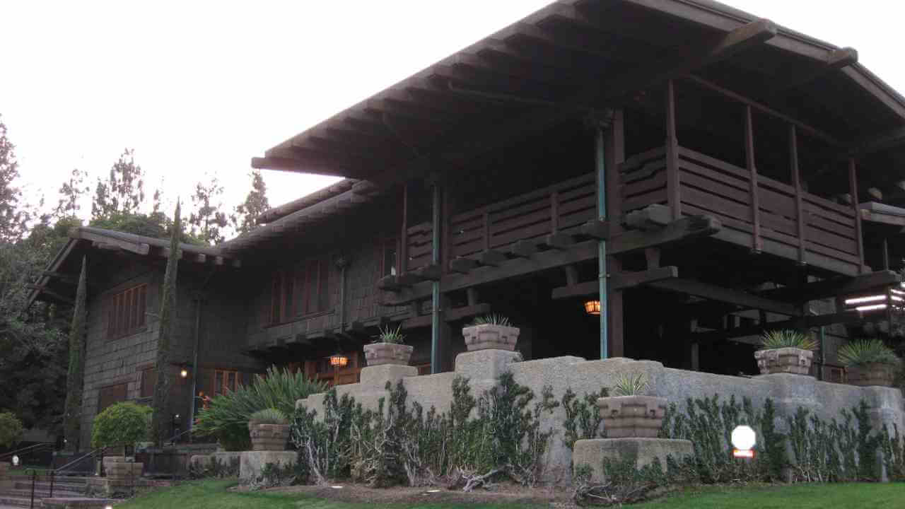 a large wooden house sitting on top of a lush green lawn