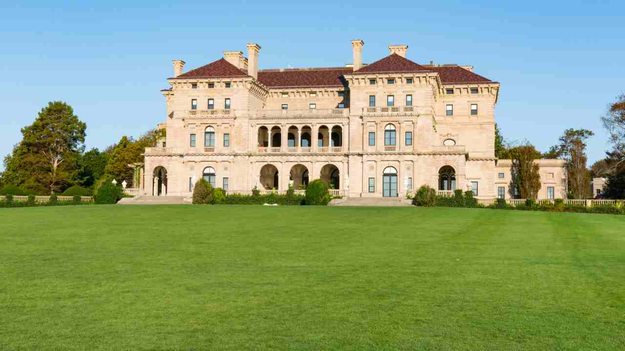 a large mansion sitting on top of a lush green field