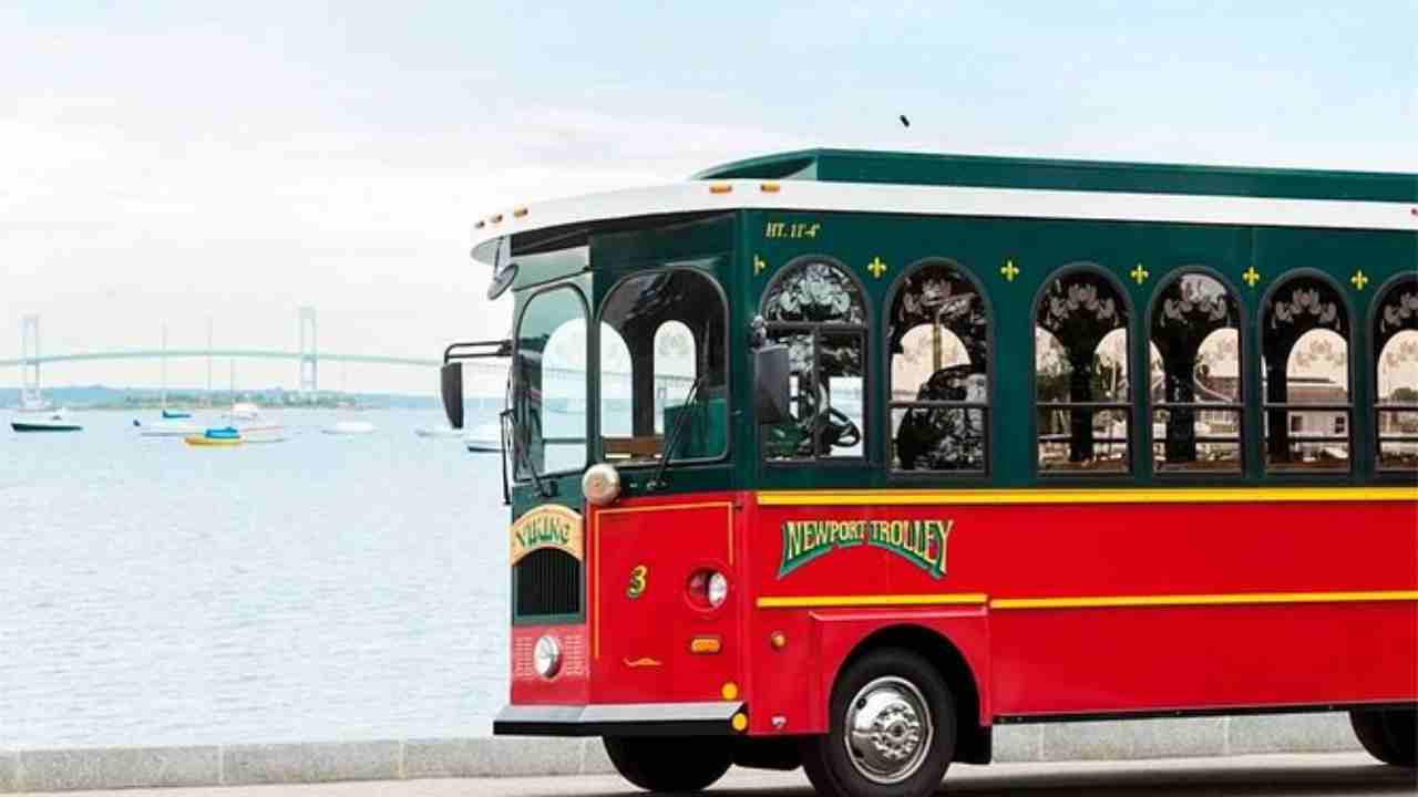 a red and green trolley on the side of the road