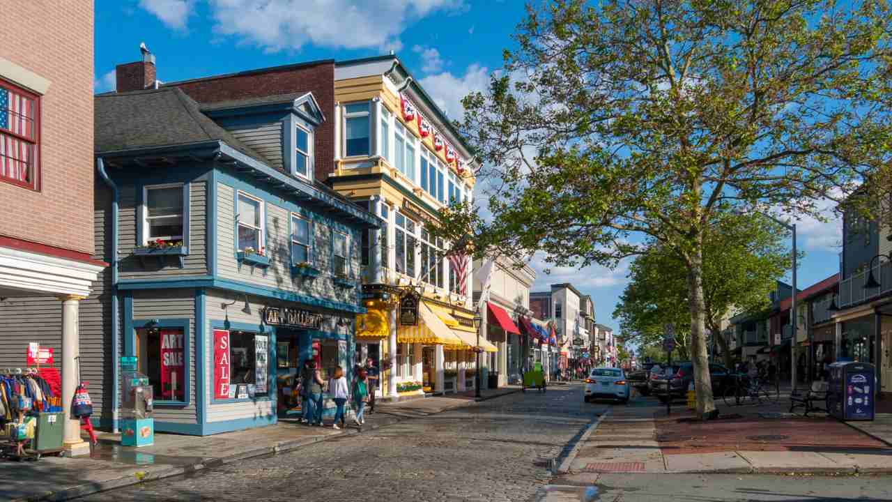 a city street with shops and people walking on it