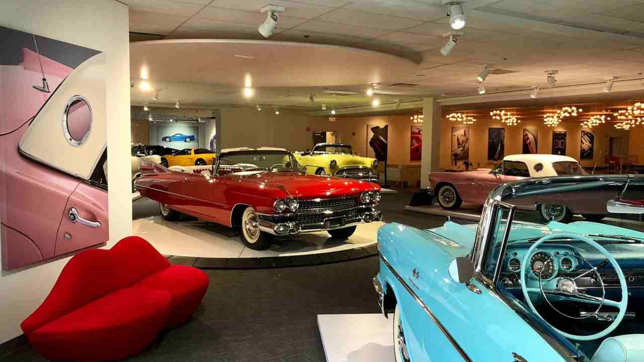 several classic cars are on display in a museum