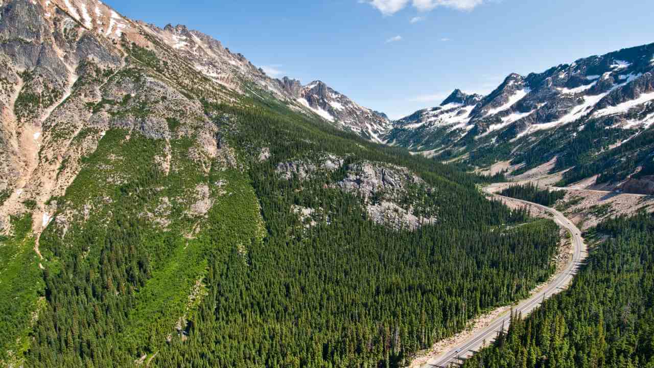 an aerial view of a winding road in the mountains