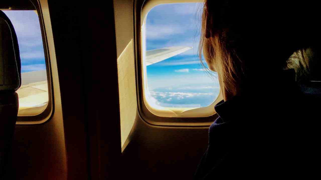 a person looking out the window of an airplane