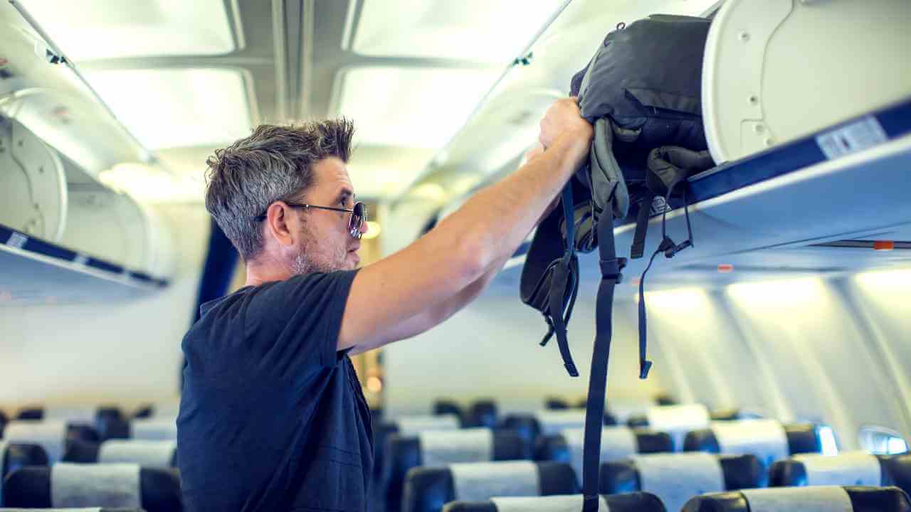 a person with a backpack on the back of an airplane