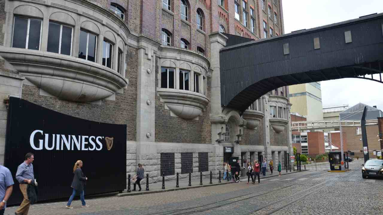 the guinness sign is on the side of a building