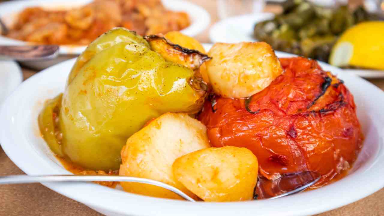 a bowl filled with potatoes, peppers and other vegetables