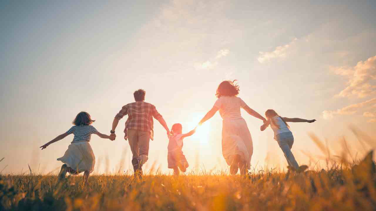 a family running through a field at sunset - family stock videos & royalty-free footage