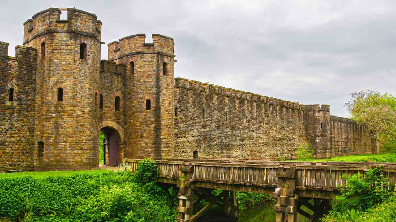 an old stone castle with a bridge over a river