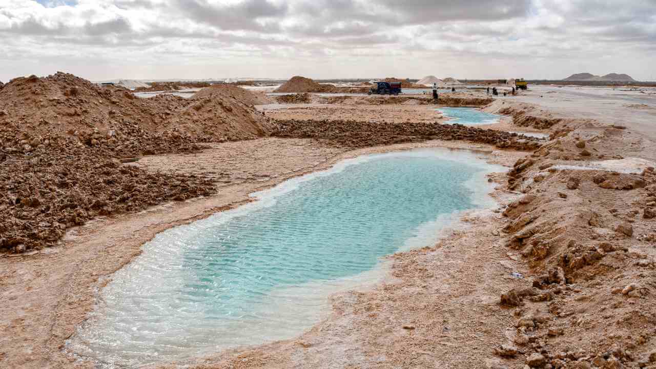 a pool of water in the middle of a desert