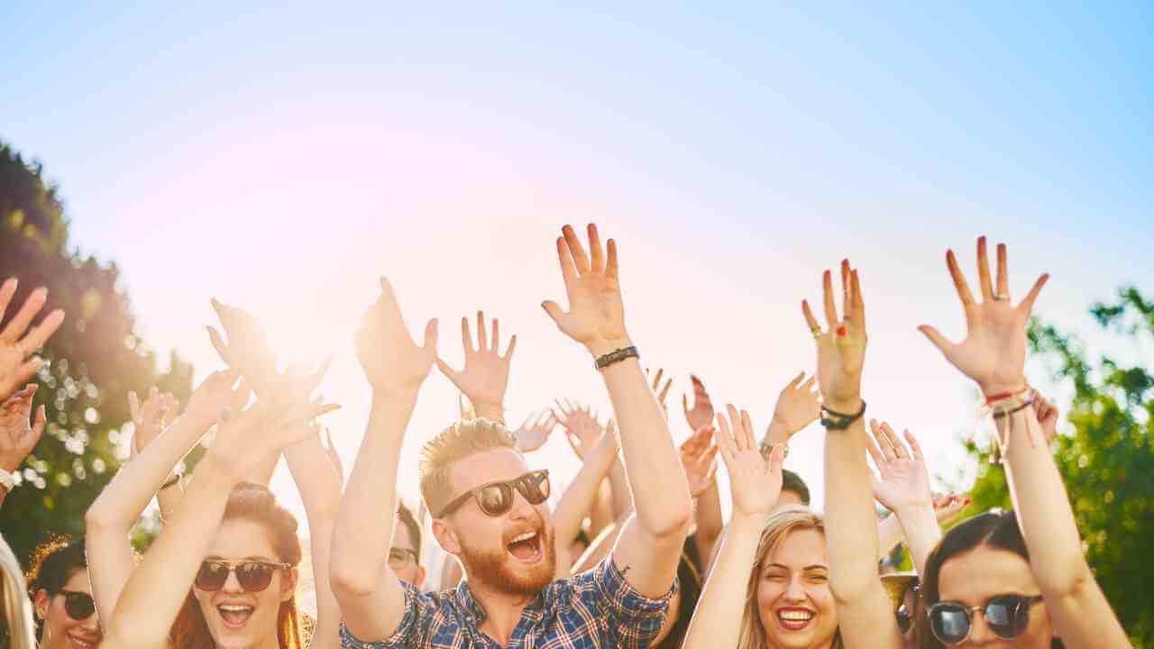 a group of people with their hands up in the air