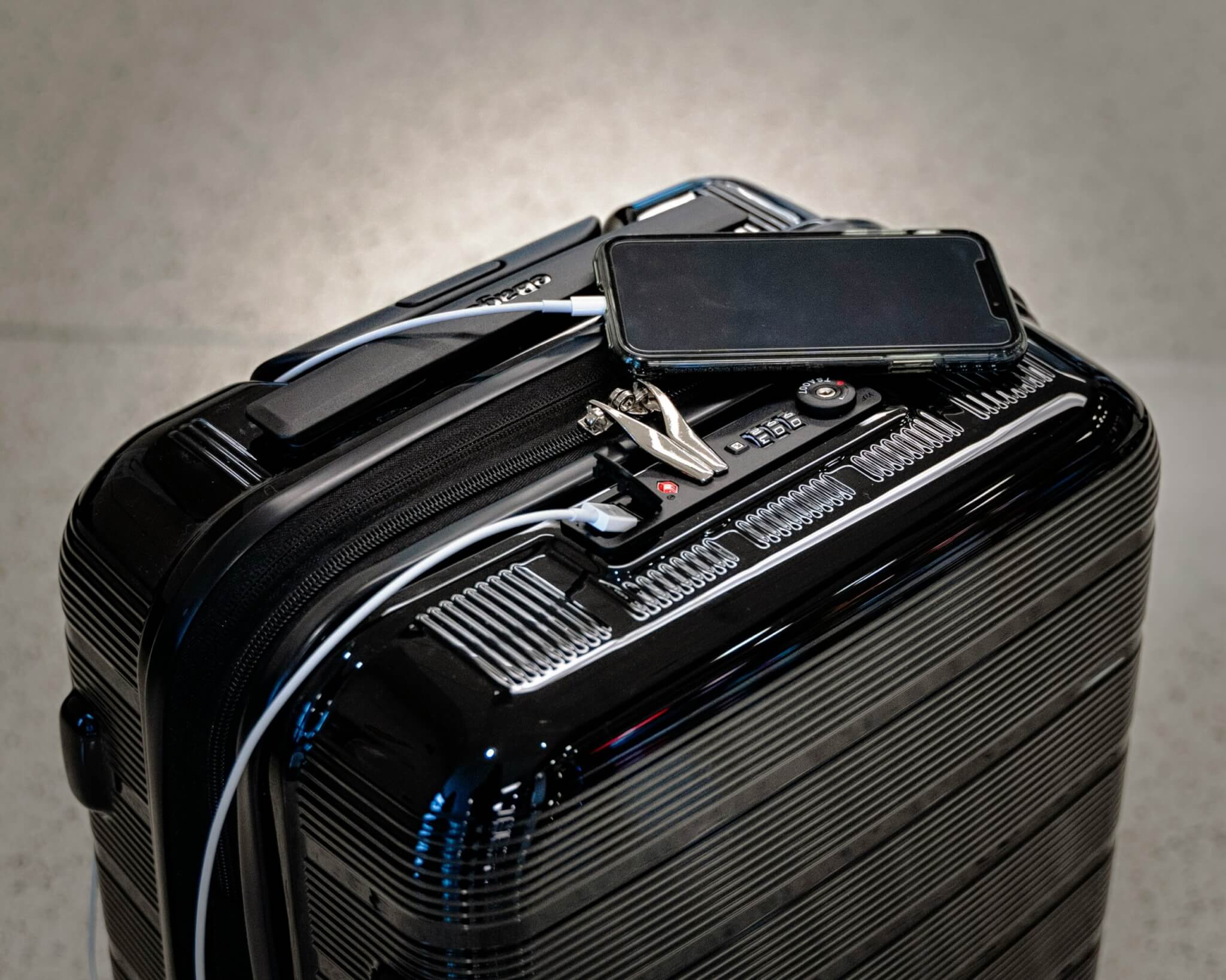 cell phone charging on luggage