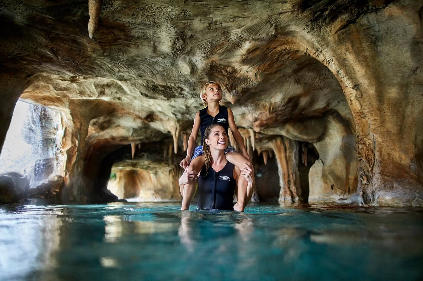 mother and son in a pool grotto