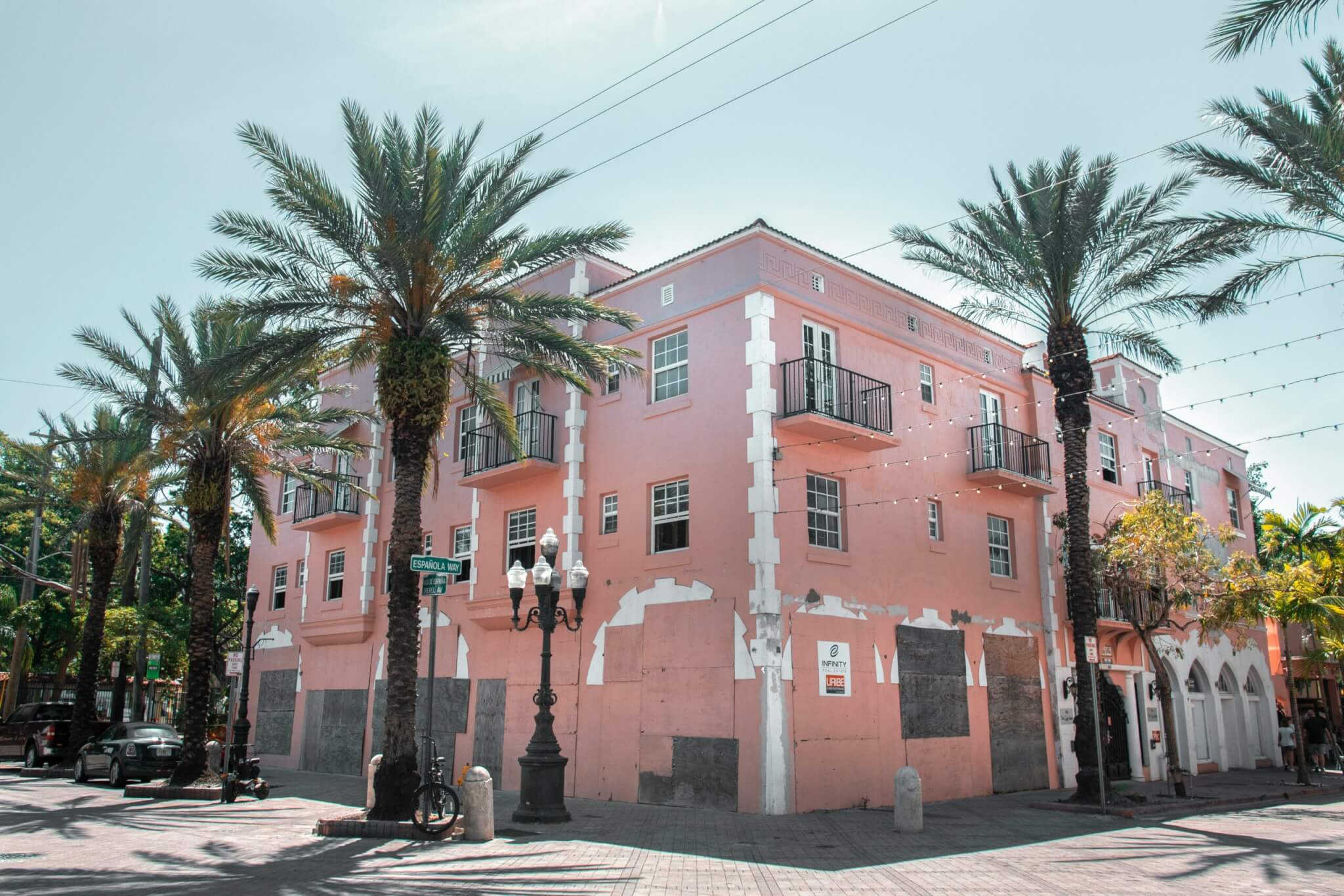 pink building with palm trees around it